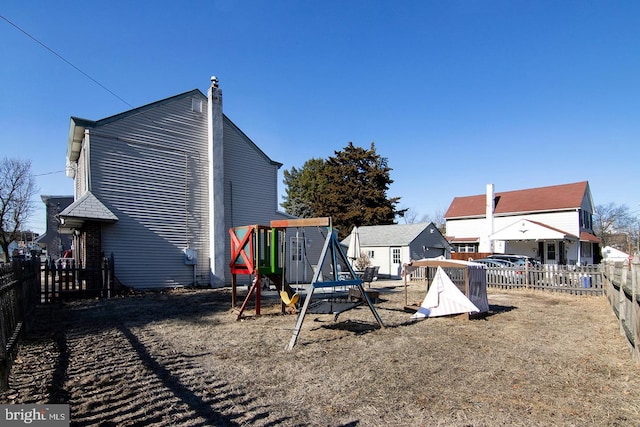 view of yard with a fenced backyard and a playground