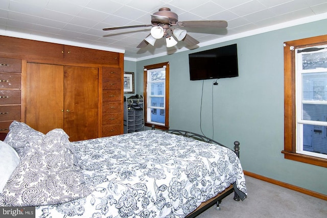 bedroom featuring light carpet, baseboards, and a ceiling fan