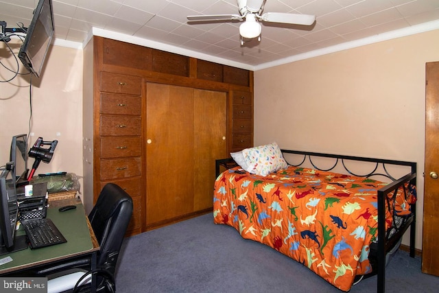 carpeted bedroom with ornamental molding and ceiling fan