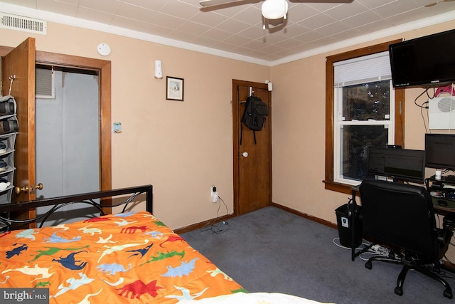 carpeted bedroom with visible vents, crown molding, and baseboards