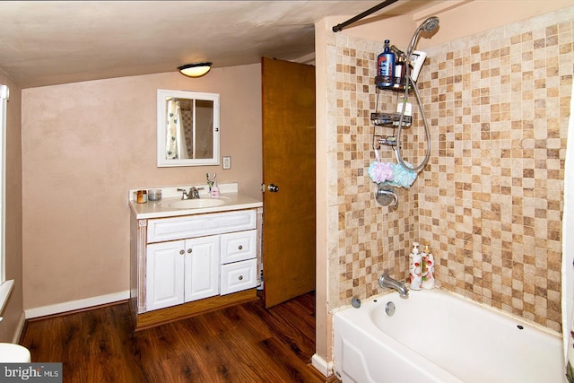 full bathroom featuring bathtub / shower combination, vanity, baseboards, and wood finished floors