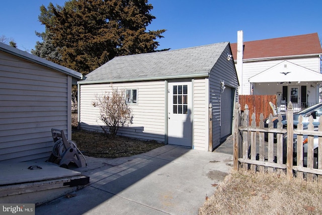 view of outbuilding featuring an outbuilding and fence