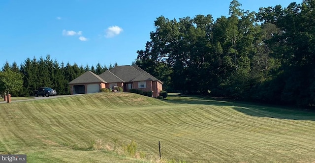 view of front of house featuring a garage and a front yard