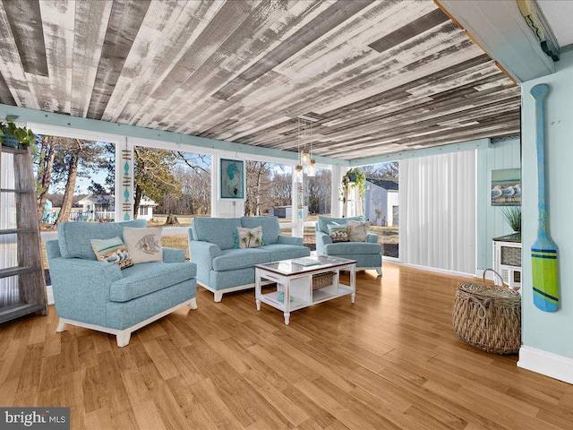 living room with light hardwood / wood-style flooring and wooden ceiling