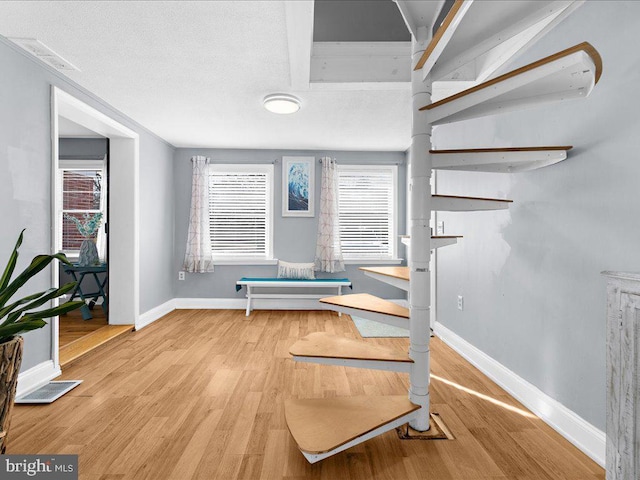 sitting room featuring a healthy amount of sunlight and hardwood / wood-style floors