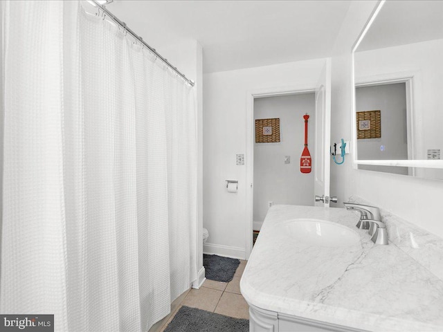 bathroom with vanity, tile patterned floors, and toilet