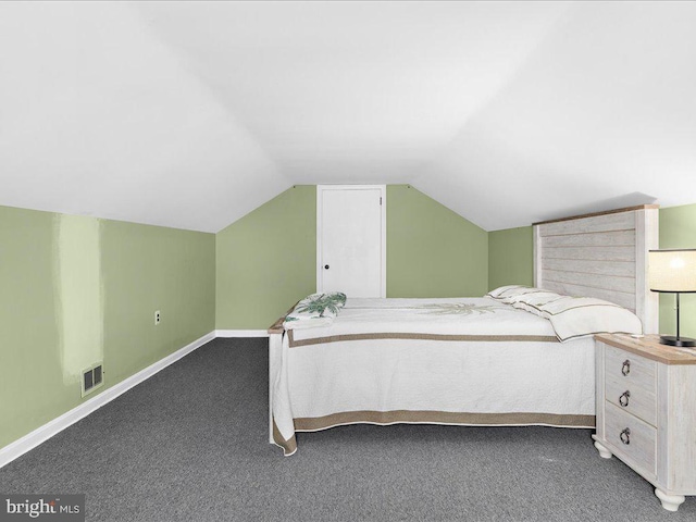 carpeted bedroom with lofted ceiling