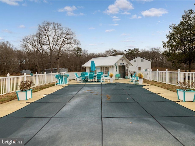 view of swimming pool with a patio and an outdoor structure