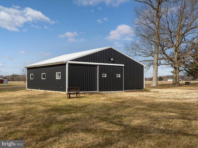 view of outbuilding featuring a yard