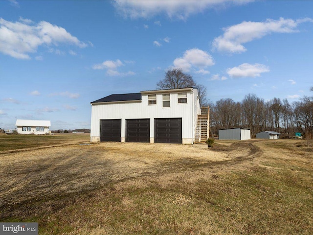 garage featuring a lawn