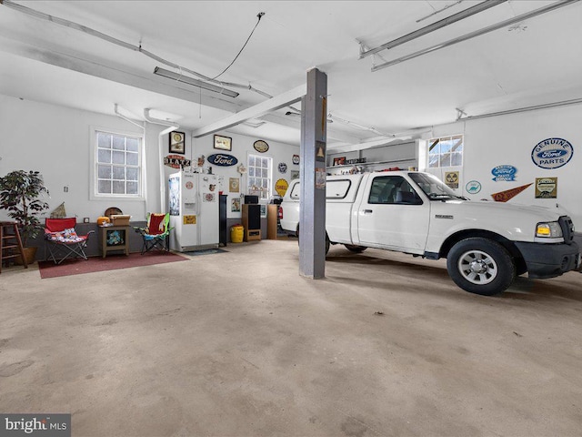 garage with white fridge with ice dispenser