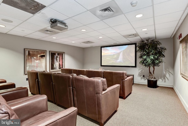 carpeted cinema featuring a drop ceiling