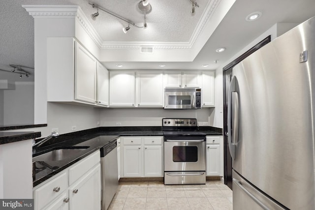 kitchen with white cabinetry, light tile patterned floors, a textured ceiling, and appliances with stainless steel finishes