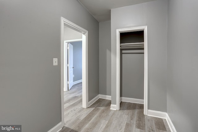 unfurnished bedroom with light hardwood / wood-style floors and a closet