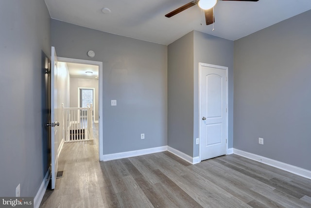 unfurnished bedroom featuring ceiling fan and light wood-type flooring