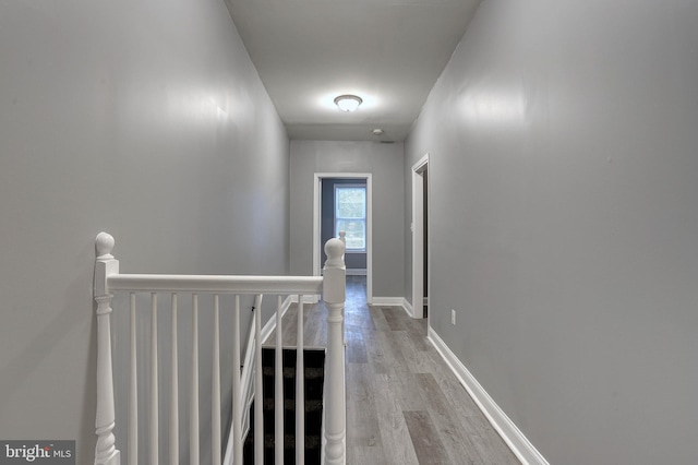 hallway with light hardwood / wood-style flooring