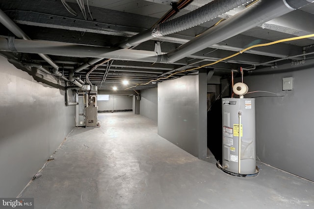 basement featuring heating unit and electric water heater