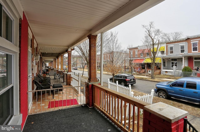 wooden terrace featuring covered porch