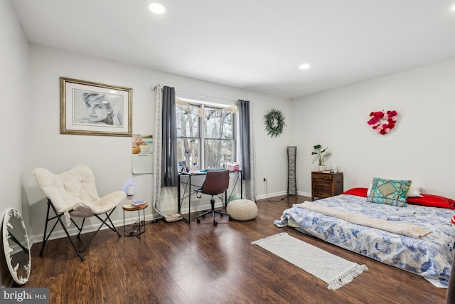 bedroom with dark hardwood / wood-style floors