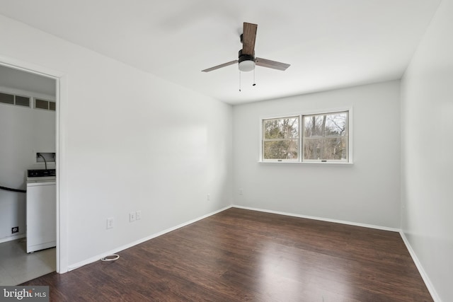 unfurnished room with ceiling fan, washer / clothes dryer, and dark hardwood / wood-style flooring