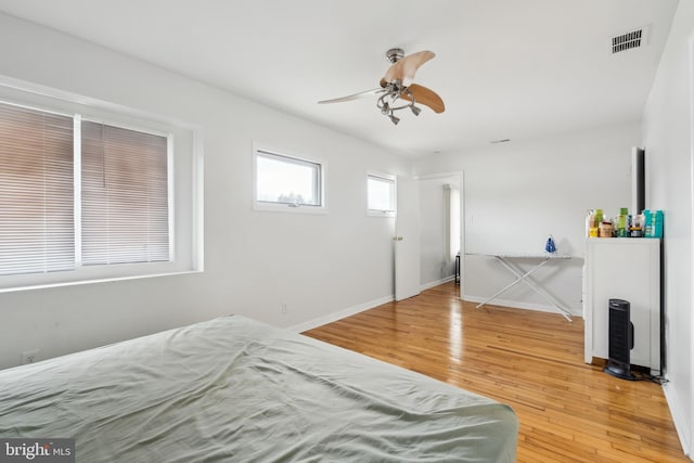 bedroom with ceiling fan and wood-type flooring