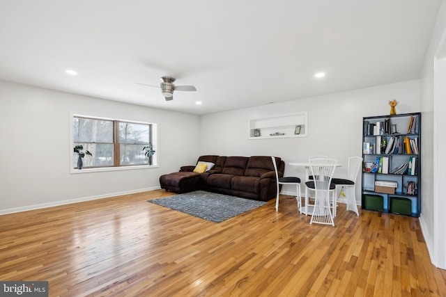 living room featuring ceiling fan and light wood-type flooring