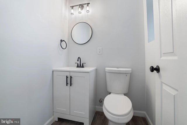 bathroom featuring hardwood / wood-style flooring, vanity, and toilet