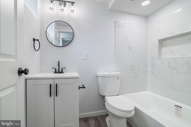 full bathroom featuring vanity, toilet, tiled shower / bath combo, and wood-type flooring