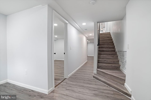 stairway with hardwood / wood-style flooring