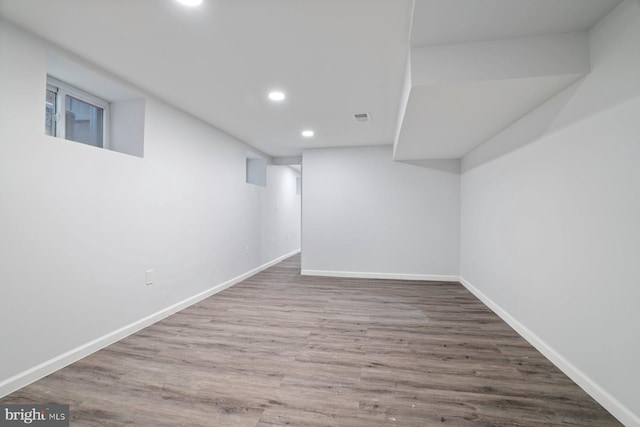 basement with hardwood / wood-style flooring