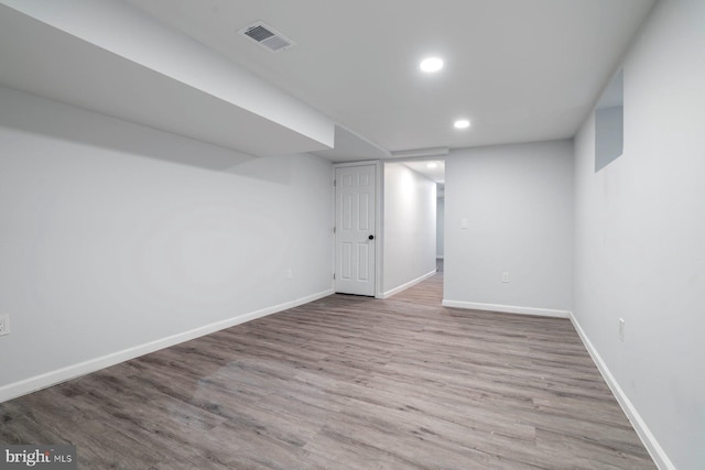 basement with light hardwood / wood-style floors