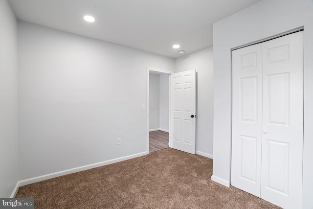 unfurnished bedroom featuring carpet and a closet