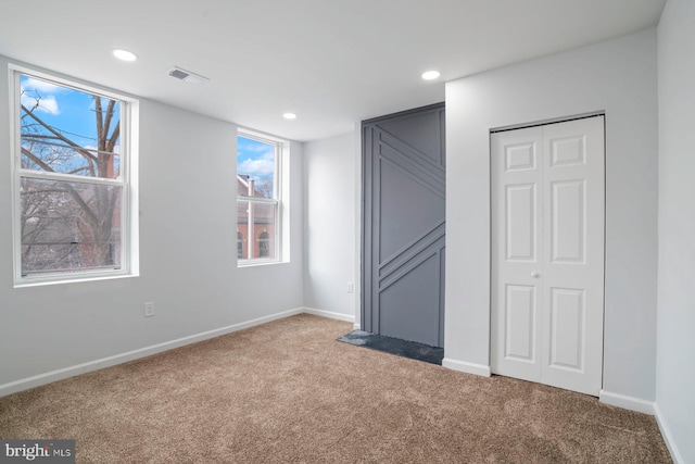 unfurnished bedroom with carpet floors and a closet