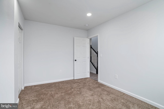 unfurnished bedroom with carpet flooring and a closet