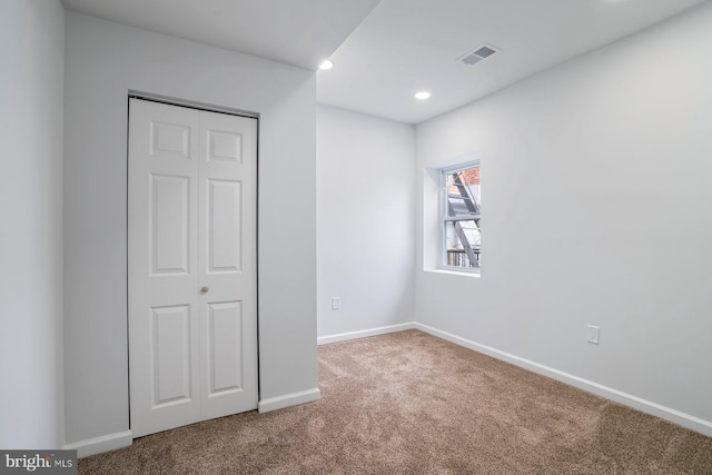 unfurnished bedroom with carpet floors and a closet