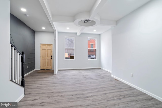 entrance foyer featuring beamed ceiling and light hardwood / wood-style floors