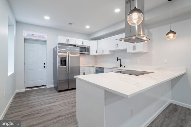 kitchen with sink, island range hood, appliances with stainless steel finishes, pendant lighting, and white cabinets