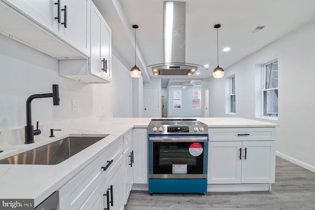 kitchen with sink, stainless steel electric range, island range hood, and white cabinets