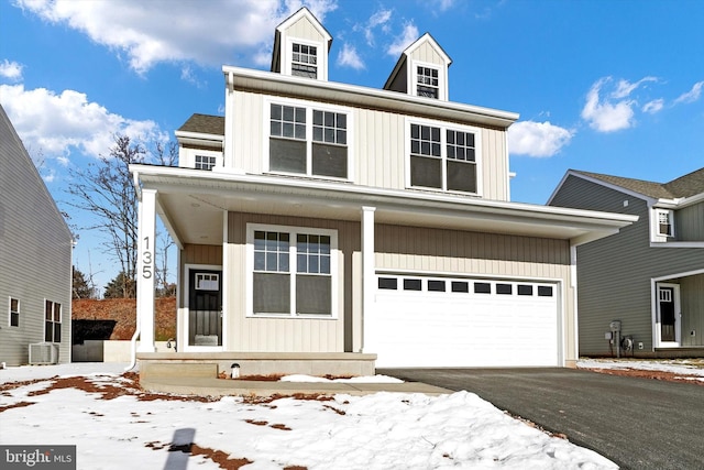 view of front of house with central AC and a garage