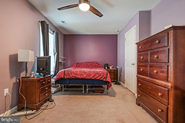 bedroom with ceiling fan and light carpet