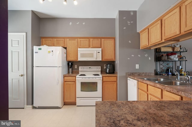 kitchen with sink, white appliances, and light brown cabinets