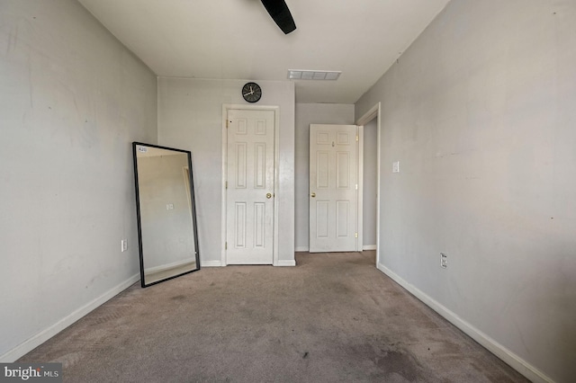 unfurnished bedroom featuring ceiling fan and carpet