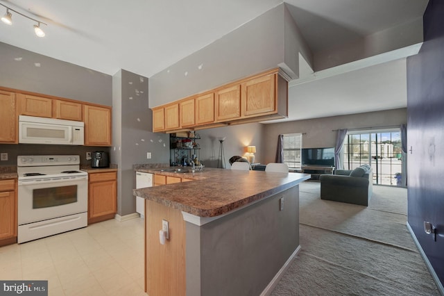 kitchen with light brown cabinetry, sink, white appliances, and high vaulted ceiling