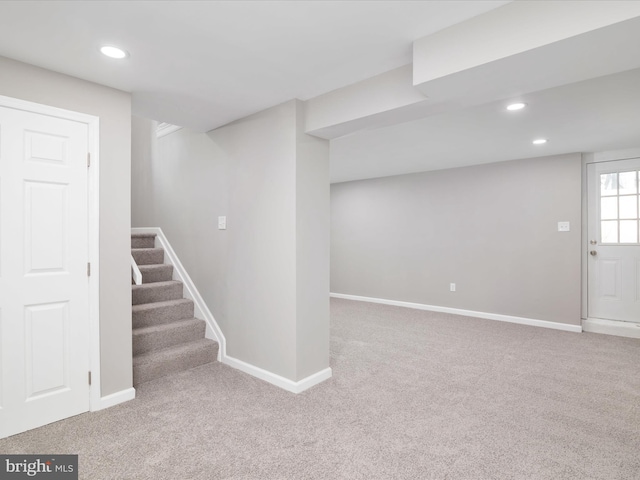 basement featuring light colored carpet