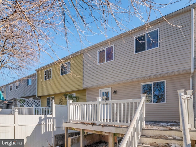 back of house with a deck