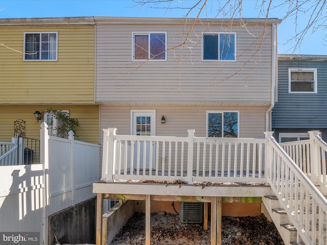 back of house with central AC and a deck