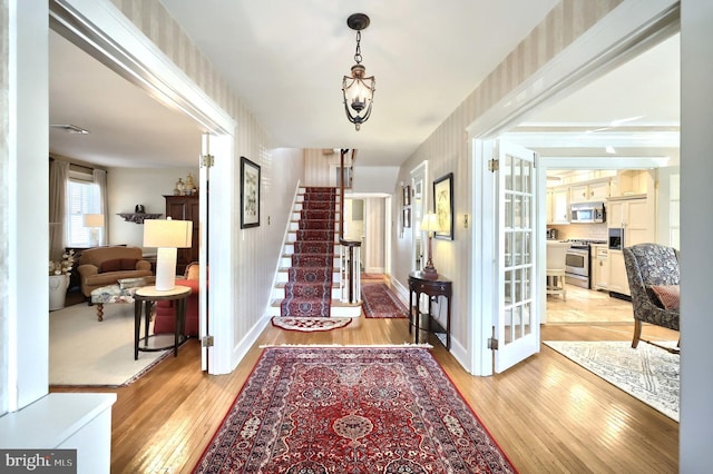 foyer entrance with light hardwood / wood-style floors