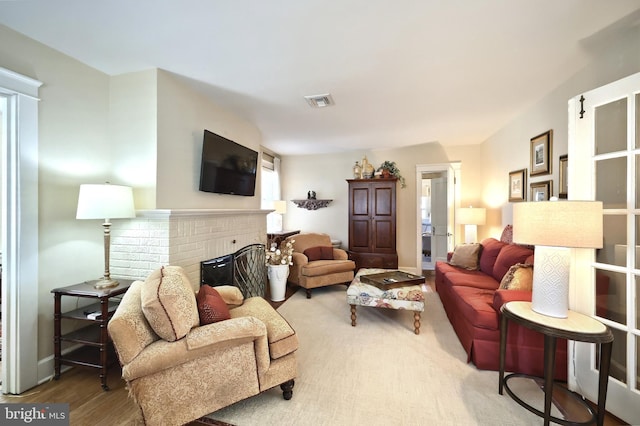 living room featuring hardwood / wood-style floors and a fireplace