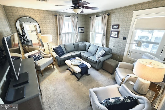 carpeted living room featuring ceiling fan