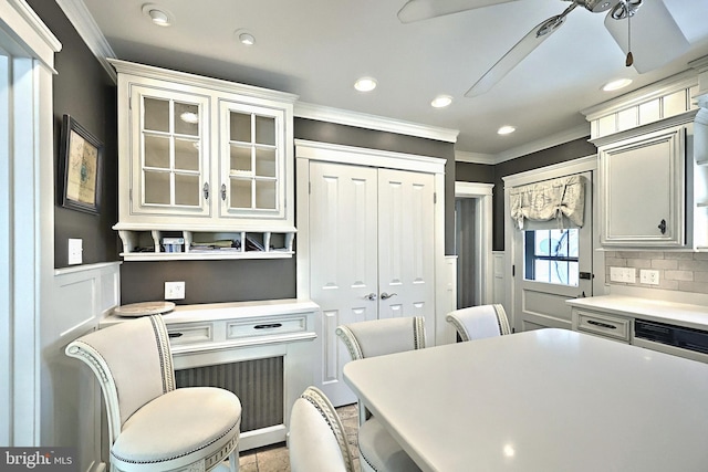 kitchen with ornamental molding, ceiling fan, and decorative backsplash